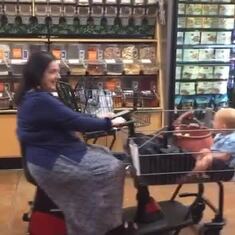 Joy giving her grandson Jove a ride in a grocery store in Boulder. 