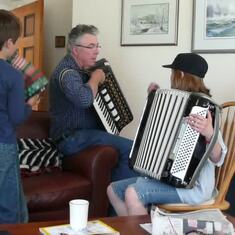 Ray plays the accordion with his grandkids