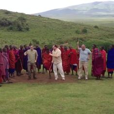 Surinder (wearing light blue shirt) on safari in Tanzania jumping with the Masai.